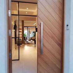 an open wooden door leading to a living room