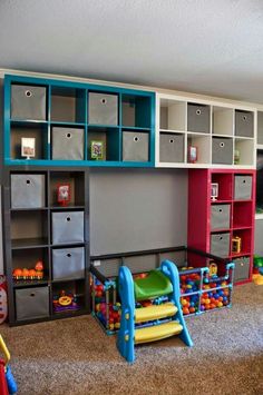 there are many toys in this playroom with colorful shelves and bins on the wall