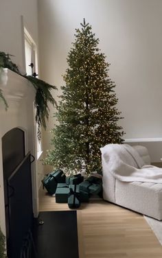 a living room with a christmas tree and presents on the floor