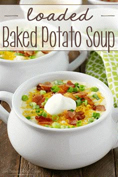 two white bowls filled with loaded baked potato soup on top of a wooden table next to a green napkin