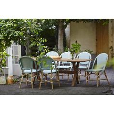 an outdoor table and chairs set up outside