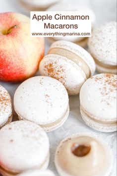 apple cinnamon macarons with powdered sugar on them and an apple in the background