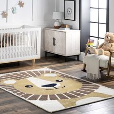 a baby's room with a teddy bear rug, crib and rocking chair