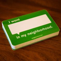 a green and white book sitting on top of a wooden table