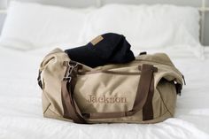 "The perfect gift for groomsmen, a thoughtful present for him on graduation, or an ideal travel companion for any adventure-seeking man. Crafted with high-quality materials and designed for both style and functionality, this Monogrammed Canvas Duffle Bag is a must-have for the modern man on the go. Made from durable 16-ounce, 100% cotton canvas, this weekender bag ensures longevity and reliability in all your journeys. Its spacious main compartment boasts ample room to accommodate your belonging Groomsmen Gift Bags, Library Book Bag, Mens Weekend Bag, Gift For Groomsmen, Canvas Duffle Bag, Leopard Bag, Large Travel Bag, Holdall Bag, Leather Weekender Bag