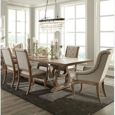 a dining room table with chairs and a chandelier