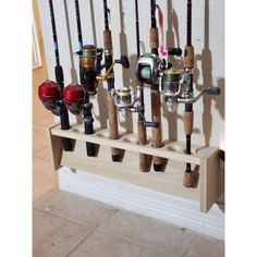 there are many fishing rods and reels hanging on the wall