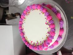 a white cake with pink and purple frosting