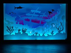 an illuminated underwater scene with dolphins and corals