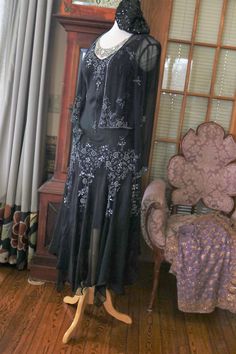 Black silk chiffon beaded Flapper dress, approx sizing from 4-8 (bias cut) Gown does include the matching beaded jacket. More pics on FB:https://www.facebook.com/pg/RetroVintageWeddings1920s1930s/photos/?tab=album&album_id=2623216997774327 Embellished Flapper Evening Dresses, Black Flapper Dress For Formal Occasions, Elegant Floor-length Ballroom Evening Dress, Black Flapper Dress For Wedding, Black Sequin Flapper Dress For Wedding, Fitted Flapper Style Evening Dress, Festive Fitted Flapper Dress For Cocktail, Festive Fitted Flapper Cocktail Dress, Black Embellished Flapper Dress For Evening