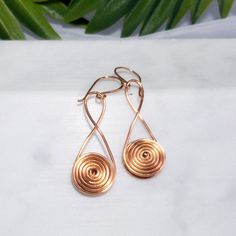 A modern, minimal take on an ancient design.  The spiral is a symbol of new beginnings.  A charming birthday, graduation, thank you, congratulations or "just because" gift.  Available in two sizes in three metals, pure copper, silver plated copper wire, and a golden bronze plated copper wire.  The larger size dangle about 2.25" and the smaller about 1.75".  Because these are individually handcrafted to order, sizes are close but approximate. Egyptian Inspired, Ancient Designs, Just Because Gifts, Bead Jewellery, Pure Copper, Copper Wire, New Beginnings, Halloween Shopping, Jewelry Earrings Dangle