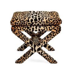 an animal print stool with two legs and a foot rest in the shape of a cross