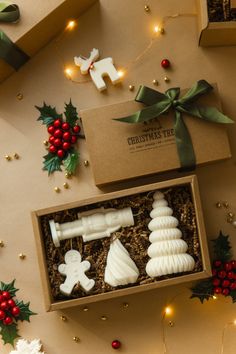 two christmas decorations in a box on a table