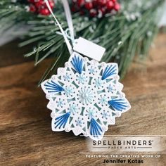 a snowflake ornament hanging from a christmas tree