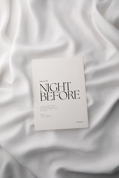 a book that is laying on top of a white bed sheet with the words night before