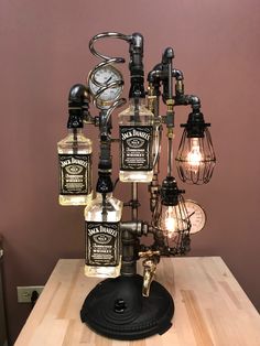 a lamp made out of bottles on top of a wooden table