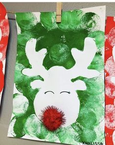 paper plate reindeers are hung on the wall with red and green paint, while another is