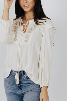 Description Floral Embroidered V neck Flutter Blouse Materials & Care 100% Viscose Gentle wash cold, Do not bleach, hang or line dry, cool iron if needed. Hand Measured Small: Length 20", Bust 19.5()", 20" Sleeve Medium: Length 21", Bust 20(40)", 21" Sleeve Large: Length 22", Bust 21(42)", 22" Sleeve Model wearing size Small ﻿﻿Model pictures have been edited, please refer to video for actual color reference. Spring Embroidered Long Sleeve Top With Ruffles, Flowy Cotton Blouse With Floral Embroidery, Cream Long Sleeve Blouse With Embroidered Sleeves, Flowy Embroidered Spring Tops, Spring Embroidered Flowy Top, Embroidered Flowy Spring Top, Spring Cream Embroidered Long Sleeve Top, Spring Embroidered Long Sleeve Top In Cream, Cream Long Sleeve Embroidered Top For Spring