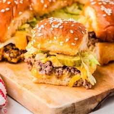 two hamburgers cut in half on a cutting board