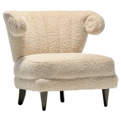 an upholstered chair with a pom - pom on it's back