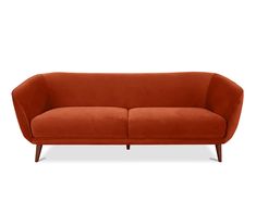 an orange couch sitting on top of a white floor