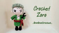 a small crocheted doll is standing next to a sign that says crochet zone