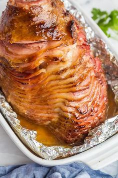 the ham is wrapped in foil and ready to be cooked