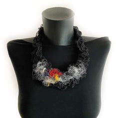 Introducing our Unique Black Statement Necklace - a true one-of-a-kind accessory, work of art that expresses individuality and personal style. Features and details: - Handmade item: This wearable work of art is meticulously handcrafted with the utmost attention to detail. Using a combination of knitting, crocheting, and stitching techniques, this necklace showcases a unique design that is both visually appealing and completely original. The black foundation of the necklace is adorned with eye-ca Handmade Red Artsy Necklaces, Handmade Black Artsy Jewelry, Handmade Red Artsy Necklace, Artsy Handmade Black Jewelry, Handmade Black Necklaces As Gifts, Black Necklaces With Unique Variations As Gifts, Black Necklace With Unique Variations For Gift, Black Jewelry With Artistic Design As Gift, Artsy Black Jewelry For Gifts