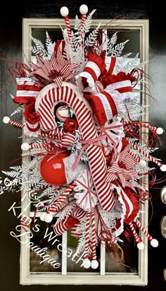 a red and white christmas wreath with candy canes