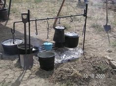 there are many buckets on the ground next to each other with water coming out of them