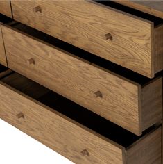 a close up of a wooden dresser with drawers