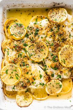 baked lemon chicken in a white casserole dish