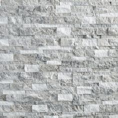 a white brick wall that is made out of stone