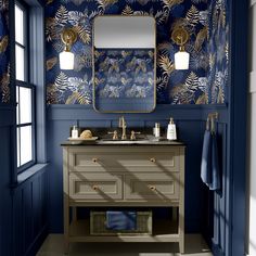 a bathroom with blue walls and gold accents