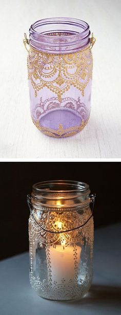 two jars with candles in them sitting next to each other