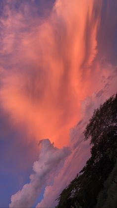 the clouds are pink and blue as the sun sets