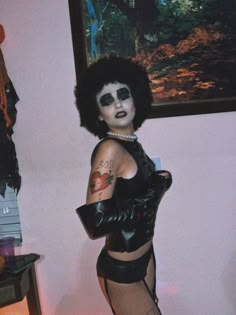 a woman with black makeup and tattoos wearing tight stockings