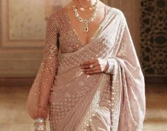 a woman in a white sari and jewelry