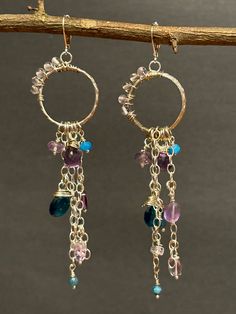 Artisan designed and handmade Pink and Purple Amethyst, Aquamarine, Apatite, and Neon Apatite Wire Wrapped Sterling Silver Hoop dangling Cascading gemstone Earrings.  The hoop has a design, the pink amethyst beads wire wrapped on it, dangling underneath is Ss chain where the beads are cascading on the chain. Attached are teardrops and other pink and purple amethyst beads. The deep rich blue in the neon apatite briolette has faceted brilliant shine catching the light.  These glimmering earrings a Earring Wire, Earring Making, Amethyst Beads, Pink Amethyst, Beads And Wire, Sterling Silver Hoops, Pink And Purple, Silver Hoops, Measurement Length