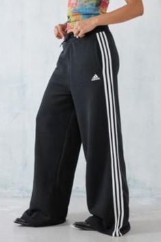 Easy athleisure track pants by adidas, complete with a 3-Stripes design and Trefoil logo print. Super wide-fit style Ft. an elasticated drawstring waist and side pockets. **Content + Care** \- 100% Recycled polyester \- Machine wash **Size + Fit** \- Model is 172cm/5'8" and wearing size 8 | adidas Black 3-Stripes Wide Leg Track Pants - Black XS at Urban Outfitters Pans Adidas, Wide Leg Track Pants, Athletic Chic, Vintage Wash Jeans, Adidas Casual, Sports Outfits