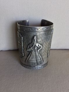 Vintage Peruvian Folkloric Sterling Long Cuff Bracelet - Artistic Etched Picture w Onlayed Design - Fine Execution - Makers Mark, Peru, .925 - No Scratches, Cracks or Dents - Like New Vintage Condition Etched Design is of a Tiled Walkway and Patterned Wall with Etched Onlays of Woman wearing Shawl, Window and Doorway on Street Scene.  Beautiful Scallop Design etched into edges of bracelet - Spanish Colonial influence Specifications:  Total Weight: circa 151.1 grams (c 5.32 oz) Size:  circa 3 1/2" L x Tapers from 2 3/8" to 2 5/8" W - Opening on back c 1 3/8" Flexible enough to open wider to accommodate a larger arm. Smooth Edges for a NO Scratch Wear. Installment Payments Available at Checkout!  Returns accepted if in Original Shipped Condition - Do NOT Polish It will be necessary to sign f Artistic Handmade Ceremonial Jewelry, Artistic Silver Cuff Bracelet Bangle, Artistic Silver Cuff Bracelet, Artistic Silver Cuff Bangle Bracelet, Traditional Handmade Sterling Silver Bracelet For Formal Occasions, Artistic Silver Bangle Cuff Bracelet, Artistic Engraved Formal Jewelry, Artisan Silver Etched Cuff Bracelet, Ceremonial Silver Metal Cuff Bracelet