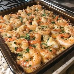 a casserole dish with shrimp and parsley in it