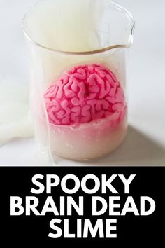 a glass filled with milk and a pink brain in it