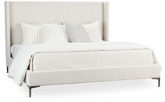 a bed with white linens and pillows on it's headboard, against a white background