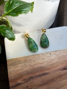 Beautiful emerald green colored earrings made from polymer clay, with small flecks of gold to give a perfect glimmer and shine. Hand painted gold on the edges. Incredibly deceivingly light weight. Each pair of earrings is made individually, thus each pair will be unique. Elegant Green Resin Earrings, Green Resin Drop Earrings, Irish Earrings, Celtic Green, Colored Earrings, Emerald Green Earrings, Green Earrings, Huggies Earrings, Teardrop Earrings