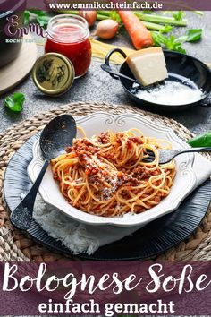 a plate of pasta with sauce and cheese on the side, surrounded by other food items