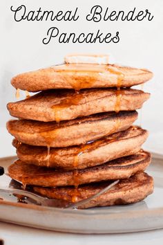 stack of oatmeal blender pancakes on a plate with syrup drizzled over them