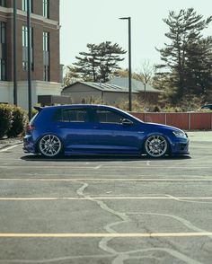 a blue car parked in a parking lot