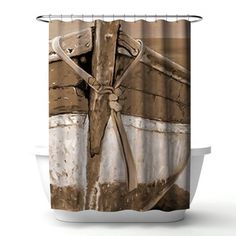 a shower curtain with an old boat on the beach in brown and white color scheme