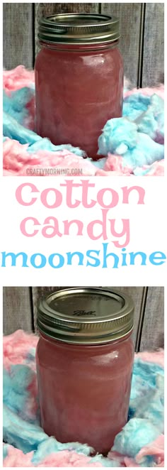 two jars filled with cotton candy sitting on top of a pink and blue table cloth